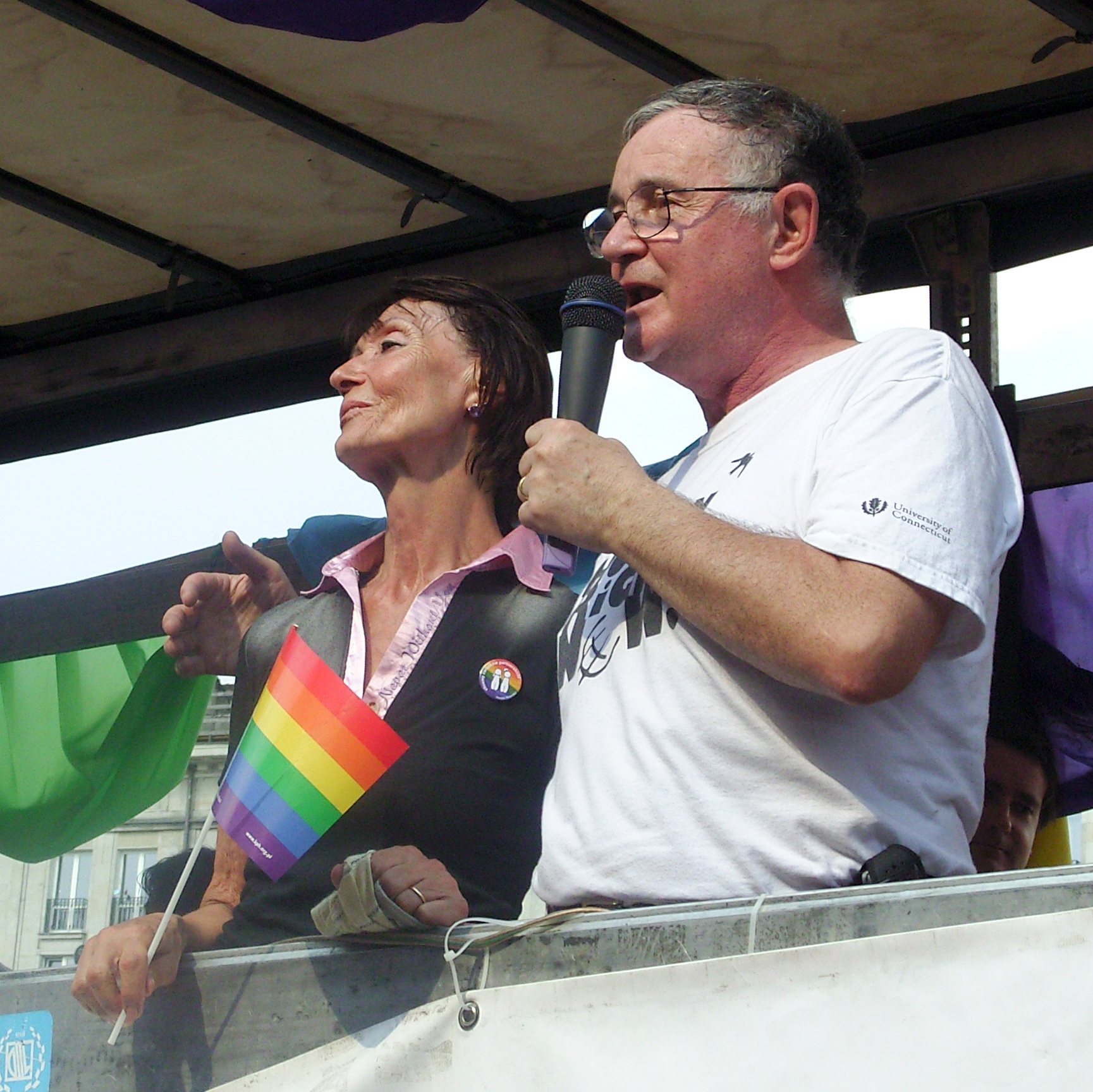Wiktor speaking at a public event with wife Ewa Woydyłło-Osiatyńska by his side.
