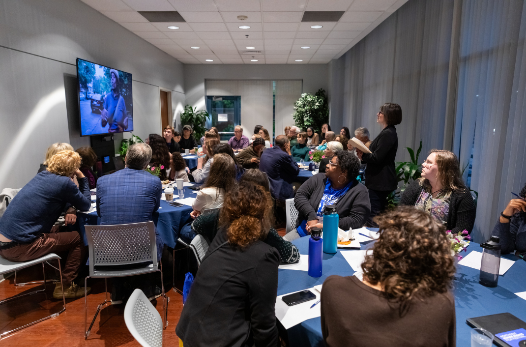 A group of people attend a dialogue at The Dodd Center