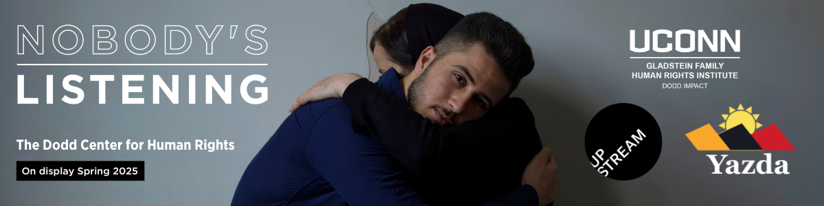An image of two Yazidi persons huddled together, part of the Nobody's Listening exhibition collection.